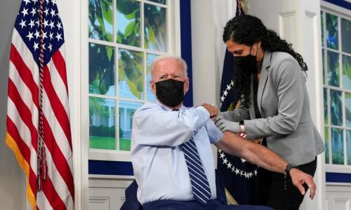President Joe Biden holds up his sleeve to receive his coronavirus booster vaccination in the Eisenhower Executive Office Building's South Court Auditorium at the White House in Washington, September 27, 2021. REUTERS/Kevin Lamarque President Joe Biden holds up his sleeve to receive his coronavirus booster vaccination in the Eisenhower Executive Office Building's South Court Auditorium at the White House in Washington, September 27, 2021. REUTERS/Kevin Lamarque
