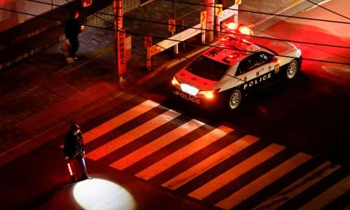 A police officer tries to control traffic on the street during an electric stoppage after an earthquake in Tokyo, Japan March 17, 2022. REUTERS/Issei Kato A police officer tries to control traffic on the street during an electric stoppage after an earthquake in Tokyo, Japan March 17, 2022. REUTERS/Issei Kato