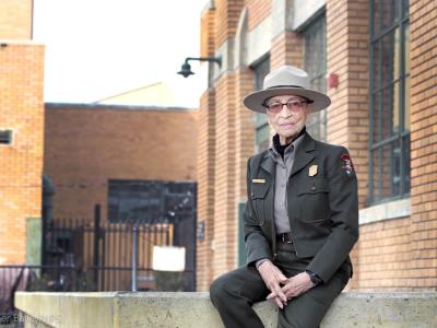 Ranger Betty Reid Soskin sits in front of the Rosie the Riveter Visitor Center. She is 96 years old. (Luther Bailey/NPS)